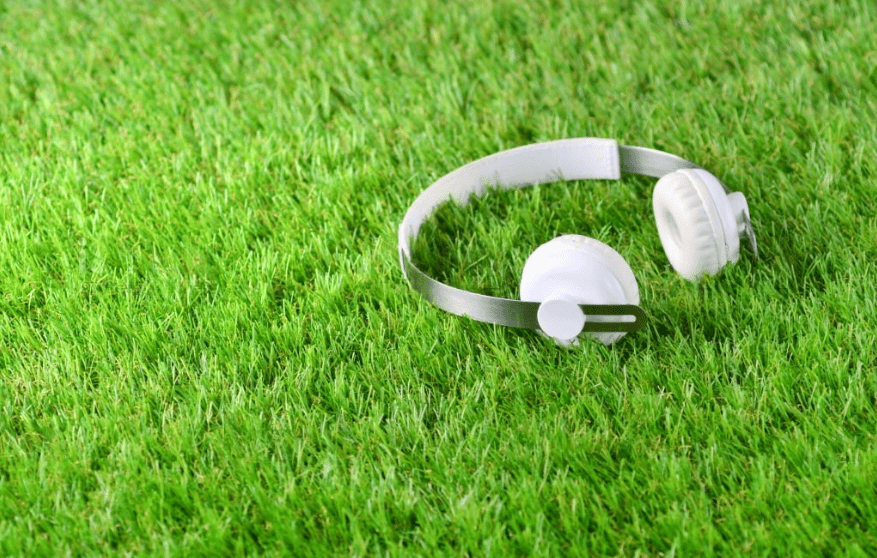A headphone lying on the artificial grass carpet