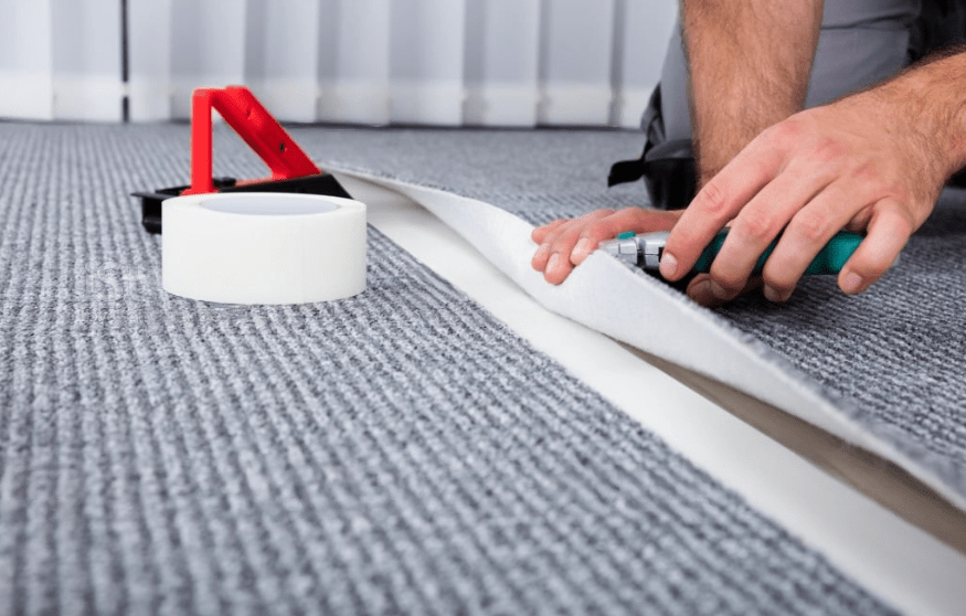 a person using a tool to install a carpet