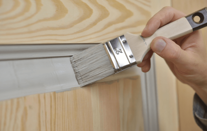 painting  the door with paint brush